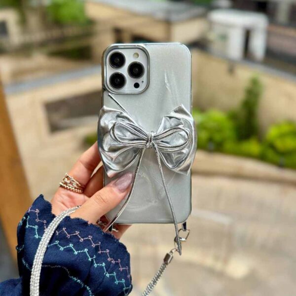 قاب پاپیون نقره ای همراه با بند ژلاتینی نگین دار مناسب برای گوشی موبایل اپل آیفون Apple iPhone 11 / 11 Pro / 11 Pro Max / 12 / 12 Pro / 12 Pro Max / 13 / 13 Pro / 13 Pro Max  / 14 Pro Max / 15 / 15 Pro / 15 Pro Max / 16 / 16 Pro / 16 Pro Max
